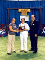 Esther Rupp, Seville, Ohio, receives the Judi Collinsworth Award from Michele Lahmers, Junior Advisory Committee member and Perry Phend, Official Judge of Junior show at Grand National Junior Holstein Show at the North American International Livestock Expo, Louisville, Ky.