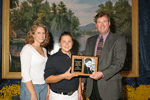 Greta Koebel, Three Oaks, Mich., receives the Judi Collinsworth Award from Julie Drendel, Junior Advisory Committee member and John M. Meyer, Holstein Association USA, Inc.?s CEO at the International Junior Holstein Show at the World Dairy Expo